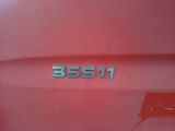 a close up of a red car with a number on it