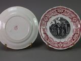 pair of red and white plates with a picture of a man and a woman