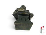 a small statue of a man sitting on a bench