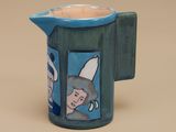 a blue pitcher with a picture of a man and a woman on it