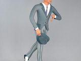 a figurine of a man in a suit and hat