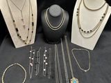 a group of necklaces and bracelets on display on a table