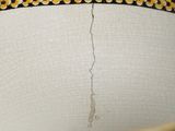 a close up view of a vase with a crack in it