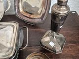 a table with a lot of silver plates and silver utensils