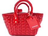 the small red basket bag has a tag attached to it