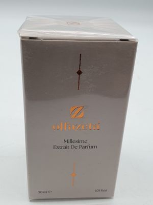 a white box with a gold logo on it sitting on a white surface