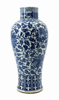 a blue and white vase sitting on a white surface