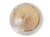 a brown lid on a silver container on a white surface