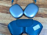 two pairs of headphones and a pair of glasses on a wooden floor