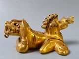 gold figurine of a horse with a rider on it ' s back