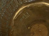 a close up of a metal bowl with writing on it