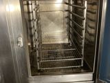 an oven that is open in the kitchen with the door open