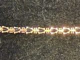 an image of a gold bracelet on display in a store