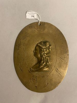 an image of a gold medallion with a man ' s head on it