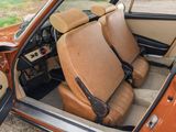 two seats in the back of a car with the door open