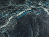 a close up of a black marble surface with blue streaks