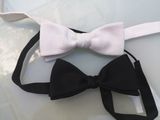 two bow ties that are tied together on a table