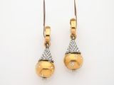 a pair of gold and diamond earrings on a white background