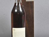 an image of a bottle of wine sitting next to a wooden box