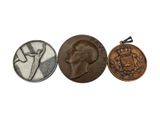three coins are shown in a row on a white surface