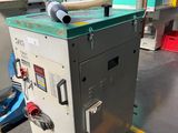 an image of a machine in a factory with a hose attached to it