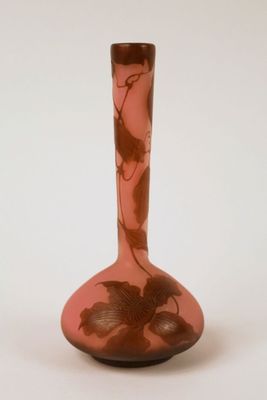 a pink vase with a floral design on it