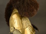an old helmet with a fur on top of it on a stand