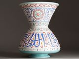 a vase that has been decorated with arabic writing on it