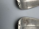 two spoons that are sitting on a table