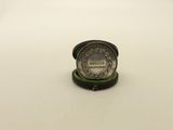 a small silver coin sitting on top of a white table