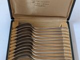 six forks in a black box with a gold handle