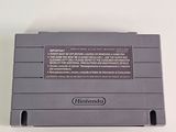 an old nintendo game console sitting on top of a white table