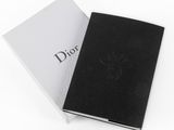 black and white photo of a book with a logo on it