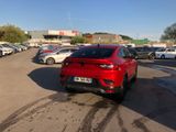 a red car that is parked in a parking lot