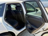 a white car with the door open and the passenger seat down