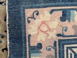 a blue rug with a design on it on the floor