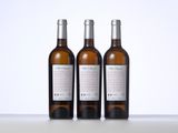 three bottles of wine sitting next to each other on a table