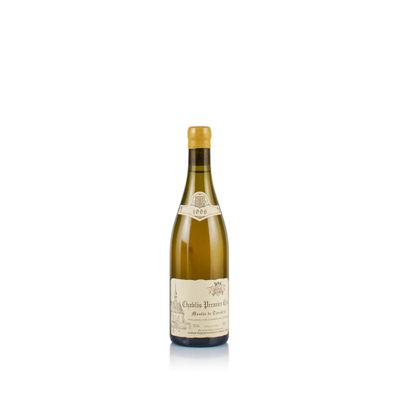 a bottle of white wine sitting on top of a white table