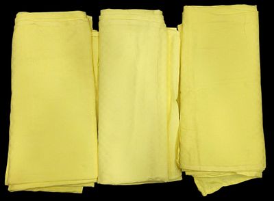 four pieces of yellow cloth folded on top of each other
