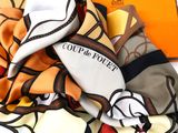 a lot of different colored silk scarves on a table