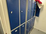 a row of blue lockers in a bathroom