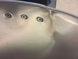 a close up of a metal pan with holes in it