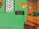 an image of a close up of a green fabric with a picture of a woman