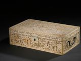 an old box with carvings on it sitting on a black surface