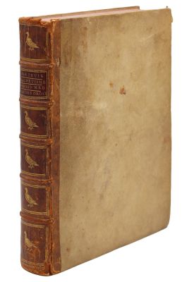 an old book sitting on top of a white surface