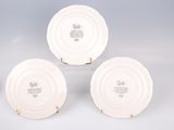 three white plates sitting on top of each other on a table