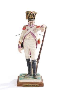 figurine of a man in a uniform with a rifle and a hat