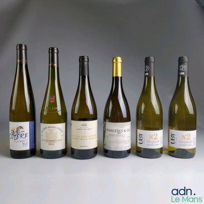 several bottles of wine are lined up in a row on a table
