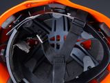 an orange helmet with a black strap on it