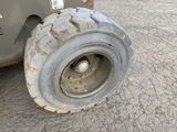 a tire that is sitting on the side of the road